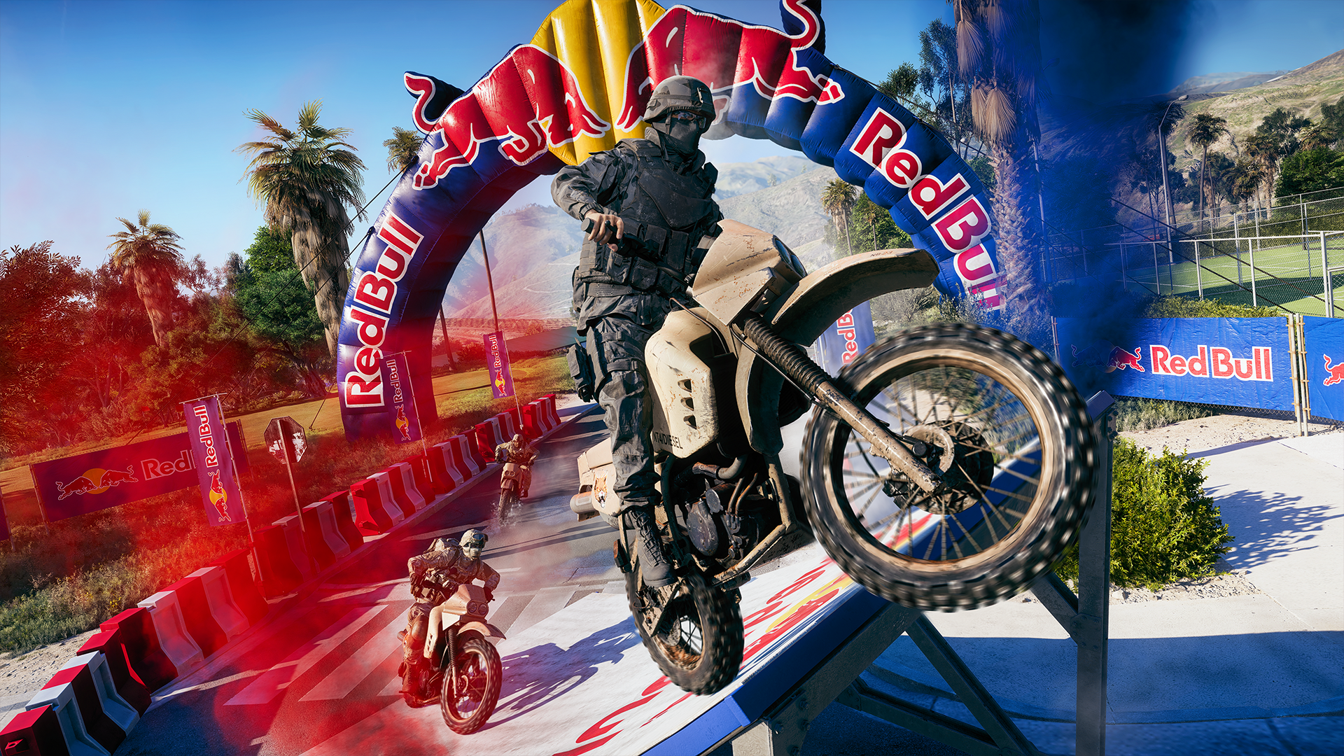 Um soldado em traje tático militar preto empinando uma moto de trilha (Dirt Bike) bege ao passar por baixo de um grande arco inflável da Red Bull em uma pista de corrida ao ar livre, com outros competidores em segundo plano.